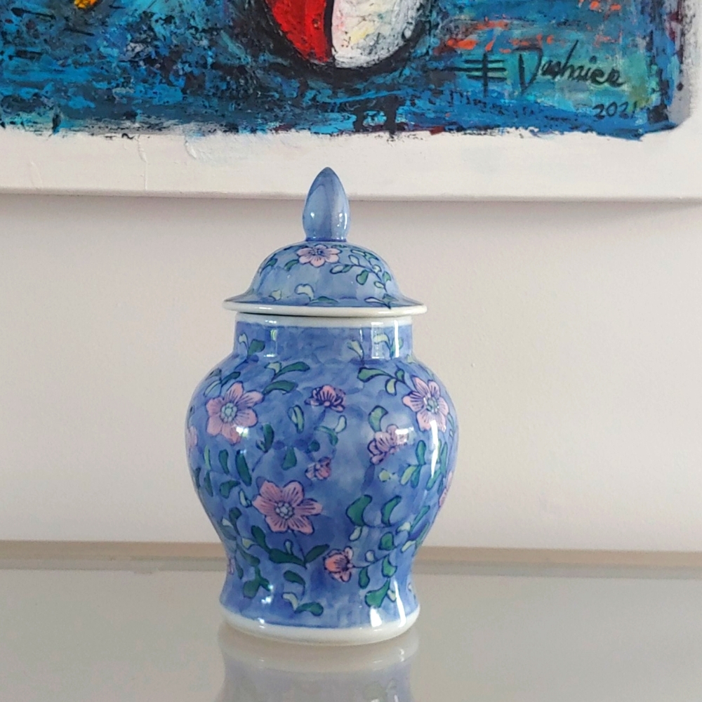 Pretty mint condition blue floral 8” tall with covered lid. Made in China.